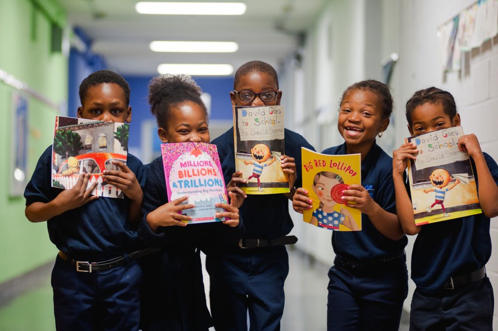 Wister Elementary students with books in hallway